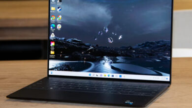 Dell XPS 13 Plus 2026 review product photo for Numerello showcasing the 3.2K OLED InfinityEdge display, seamless glass haptic touchpad, and Intel Core Ultra performance callouts.